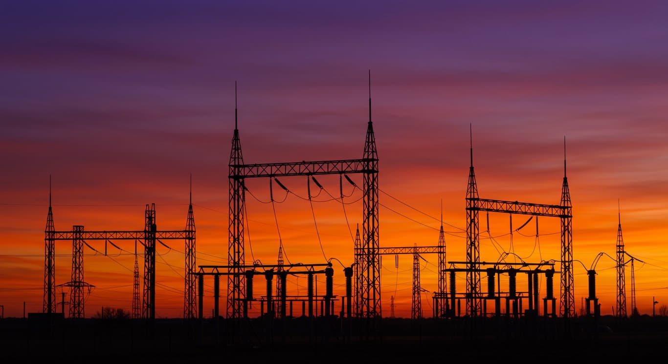 Electrical substation at dusk, representing stability and modern infrastructure.