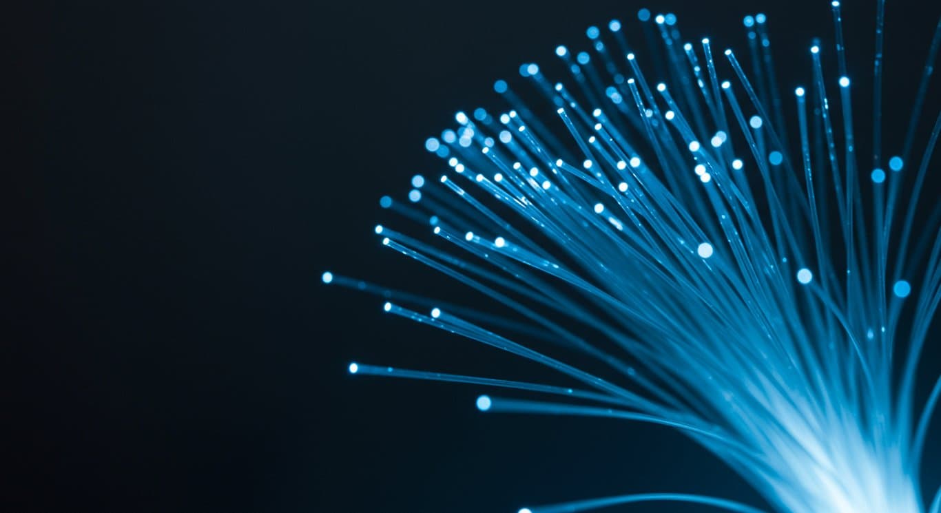 Illuminated fiber optic cables representing connectivity and technology.